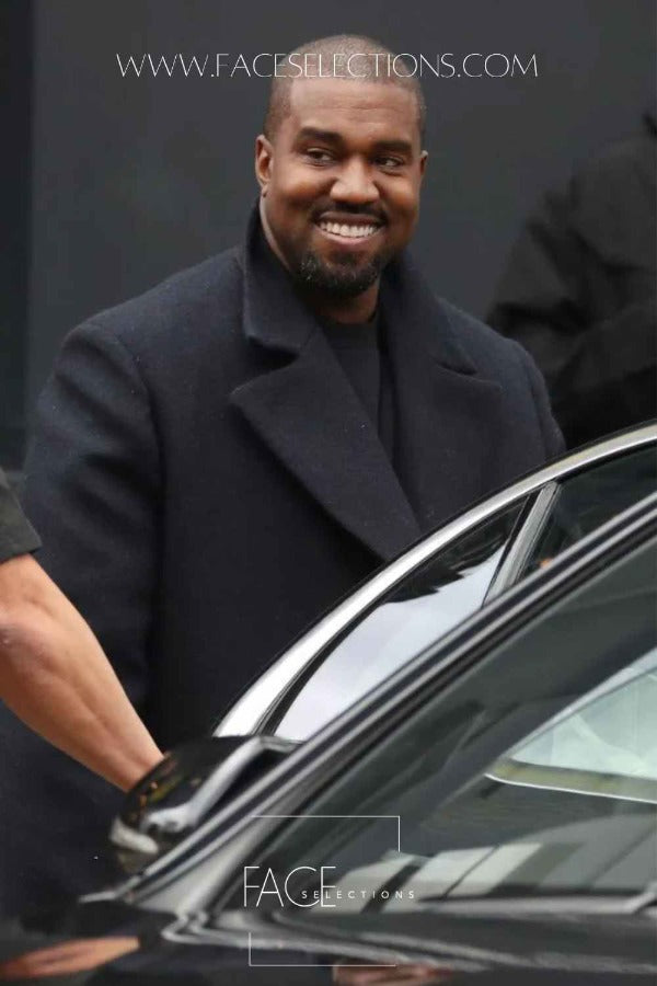 Kanye West wearing Long Coat while getting into car smiling